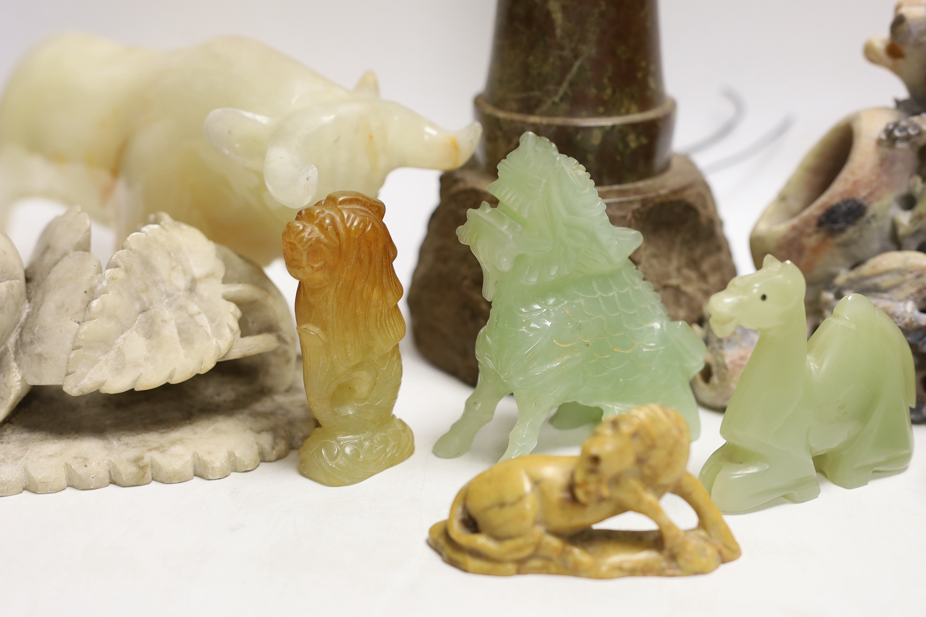 A Cornish serpentine novelty lighthouse lamp and mixed soapstone and hard stone carvings (12), lamp 25cm high